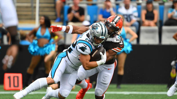 Sep 11, 2022; Charlotte, North Carolina, USA; Carolina Panthers running back Christian McCaffrey (22) is tackled by Cleveland Browns linebacker Anthony Walker Jr. (5) in the first quarter at Bank of America Stadium. Mandatory Credit: Bob Donnan-USA TODAY Sports